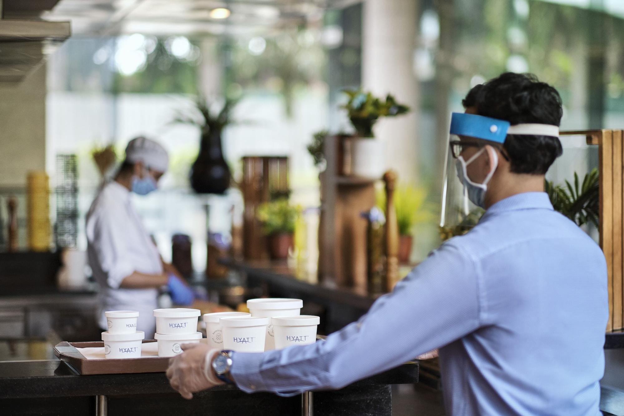Hyatt Centric Mg Road Бангалор Екстериор снимка A restaurant employee wearing a face shield